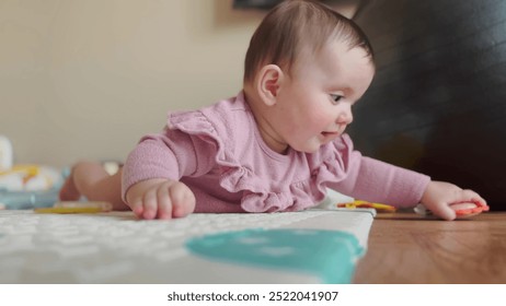 baby girl playing on the floor with a toy. happy family kindergarten kid dream concept. baby training hand rattle. newborn baby 6 months old playing on the floor in kindergarten lifestyle - Powered by Shutterstock