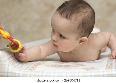 Baby Girl Playing With Rattle Toy