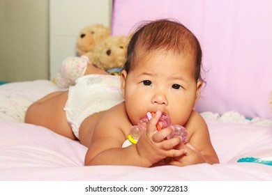 Baby Girl Playing With Rattle Toy.