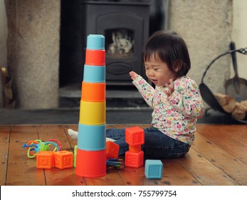 Baby Girl Playing Stacking Cups At Home