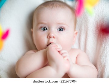 Baby Girl Pulling Foot To Mouth