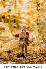 Baby Girl Running Happy Towards Camera In A Park Autumn