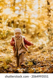 Baby Girl Running Happy Towards Camera In A Park Autumn