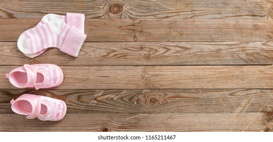 Baby Girl Shower Concept On Wooden Background, Copy Space, Top View