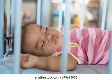 Baby Girl Is Sleeping In Baby Cot.