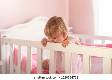 Baby Girl Standing In Wooden Crib