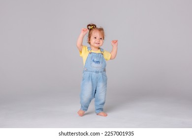 baby girl starting to walk takes her first steps on a white background - Powered by Shutterstock