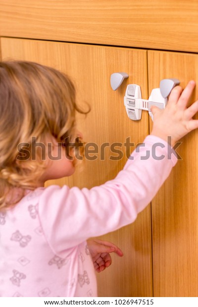Baby Girl Trying Open Kitchen Cabinet Stock Photo Edit Now