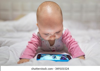 Baby Girl Watching Cartoon On The Mobile Phone