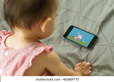 Baby Girl Watching Cartoon On The Mobile Phone