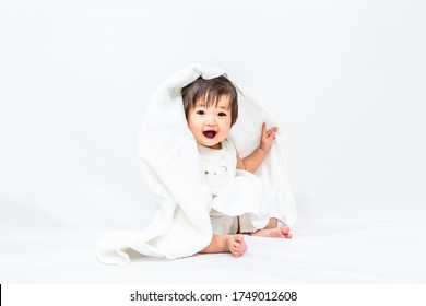 Baby girl wearing a bath towel and staring. Parenting, relaxing, happiness, images - Powered by Shutterstock