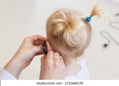 Baby Girl Wearing A Hearing Aid. Disabled Child, Disability And Deafness Concept.