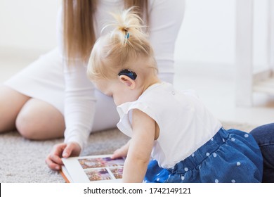 Baby Girl Wearing A Hearing Aid. Disabled Child, Disability And Deafness Concept.