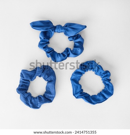 Baby hair accessories. Silk or satin hair band. Small Ribbon Bows with Elastic Hair Bands Ocean blue bow hair band isolated on white background. Trendy hairstyle.