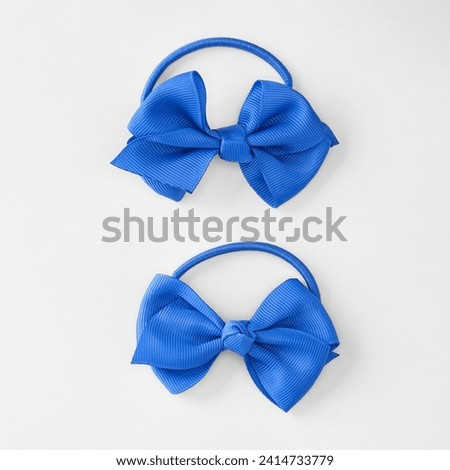 Baby hair accessories. Small Ribbon Bows with Elastic Hair Bands for Kids Girls. Ocean blue bow  hair bands isolated on white background. Trendy hairstyle.  trendy hair bow clip with ribbon work