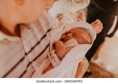 Baby Hand In Arms Of Godfather. Rite Of Sacrament Of Epiphany In Church