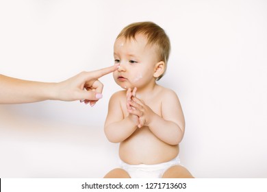 Baby Handling: Woman Applying Moisturizing Cream On Her Baby's Face