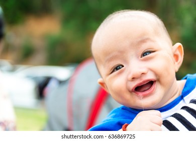 Baby Was Held By His Mother When They Traveling. He Smiled With Spit Dropping.