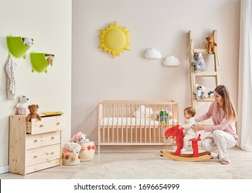 Baby And Her Mom In The Room, Decorative Interior Style With Wooden Cribbed Pink Chair Toy And Stair Decor.