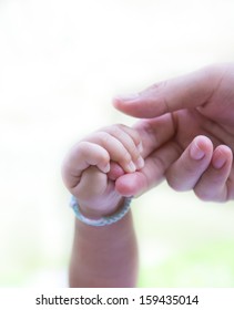 Baby Holding Adult Finger