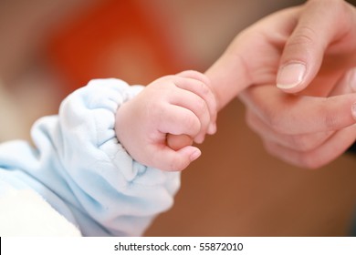 A Baby Holding His Mother's Big Finger