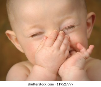 Baby Holding Nose Close Up