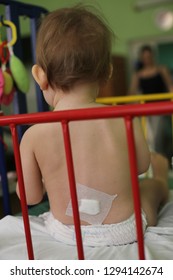 Baby In A Hospital Bed After The Surgery With A Bandaid After Spinal Anaesthesia / Healthcare. Shot In Moscow Clinic, Russia.   
