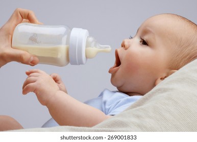 Baby Infant Eating Milk From Bottle