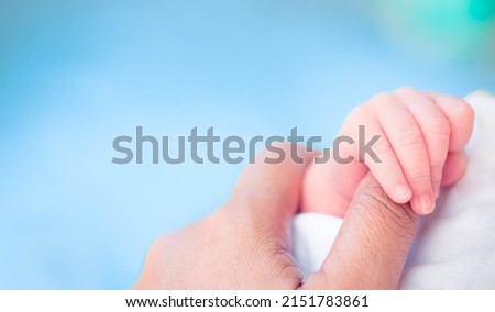 Baby infant finger hand with mother loving care.World baby day.Newborn cute.Mom and her Child.Premature or preterm baby in hospital.incubator intensive safe.foster child.Orphans infant.black people.