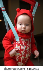 Baby In The Jumper Dressed In Red Clothes