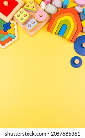Baby kids toy frame. Educational wooden toys for children on yellow background. Top view, flat lay