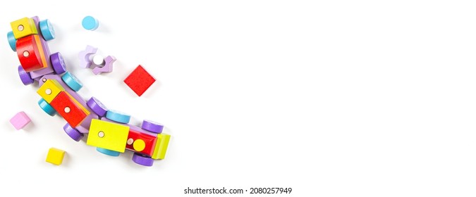 Baby Kids Toys Background. Top View To Wooden Toy Train, Wood Stacking Pyramid Tower And Colorful Wood Bricks On White Background. Early Education, Zero Waste, Montessori Toys For Children