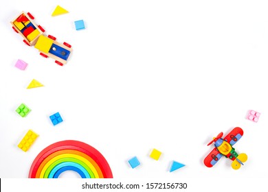 Baby Kids Toys Background. Wooden Train, Constructor Airplane, Stacking Toy Rainbow, Plane And Colorful Blocks On White Background. Top View, Flat Lay