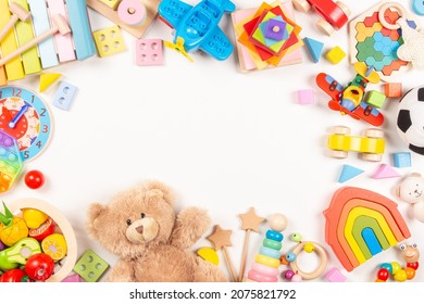 Baby Kids Toys Frame On White Background. Teddy Bear And Many Colorful Educational Wooden, Plastic Toys. Top View, Flat Lay, Copy Space For Text