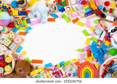 Baby Kids Toys Frame. Set Of Colorful Educational Wooden And Fluffy Toys On White Background. Top View, Flat Lay, Copy Space For Text