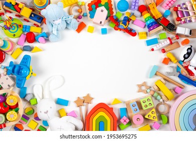 Baby kids toys frame. Set of colorful educational wooden and fluffy toys on white background. Top view, flat lay