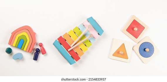 Baby Kids Toys. Top View To Colorful Educational Wooden Toys Arranged On White Background. Early Education For Kids. Learning Music For Children. Educational Montessori Toys