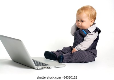 baby with laptop confused