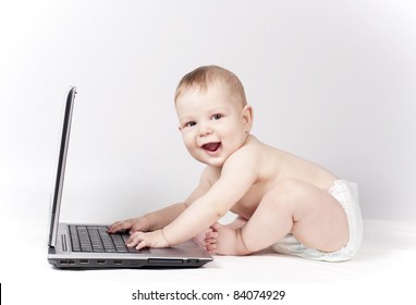 Baby with laptop on the white background