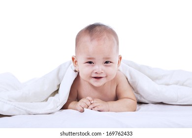 Baby Laughing Under Blanket Inside The House. Isolated On White