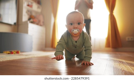 baby learns to crawl on floor at home. happy family a kid dream concept. baby son crawling on the floor first steps. baby newborn learns to crawl on the floor. baby and dad crawl lifestyle - Powered by Shutterstock