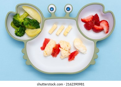 Baby Led Weaning, Blw. First Toddler Food. Soft Eco Plastic Tableware With Mixed Vegetable. Healthy Nutrition For Kid, Self Feeding. Top View Of Silicone Plate With Spoon Finger Food For Kid.