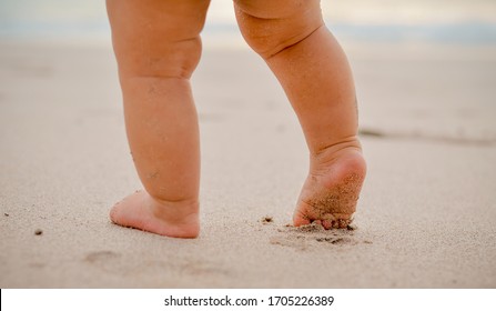 Baby legs with sand at the beach. - Powered by Shutterstock