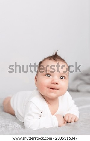 Similar – Der kleine Junge lächelt im Bett in seinem eigenen Zimmer.