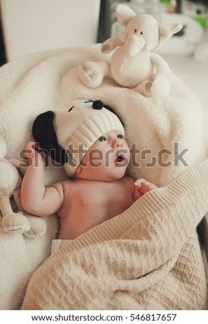 Similar – Newborn baby girl sleeping lying on bed next to mother’s hand