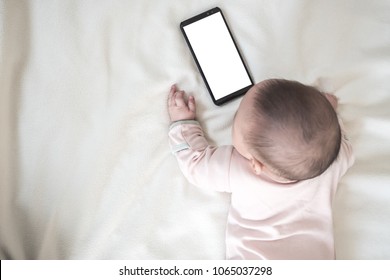 Baby Look At Screen  Mobile Phone With White Blank Screen: Mock Up Mobile App For Mom And Baby