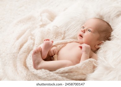 Baby looking up lying on Beige Blanket in Crib. Newborn Navel Treatment. One month Child Health Skin Care. Infant Development. Neonatal Medicine - Powered by Shutterstock