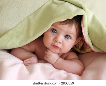 Baby Looking Out From Under Blanket