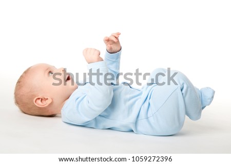 Baby Lying on Back, Happy Infant Kid Dressed in Blue Bodysuit, Beautiful Child Lie on White background looking up