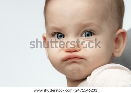 Baby makes a funny angry and sad face